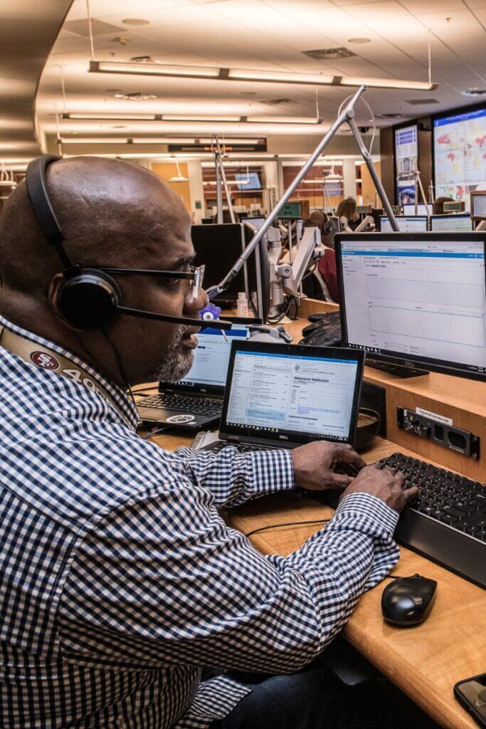 Man at computer wearing headset